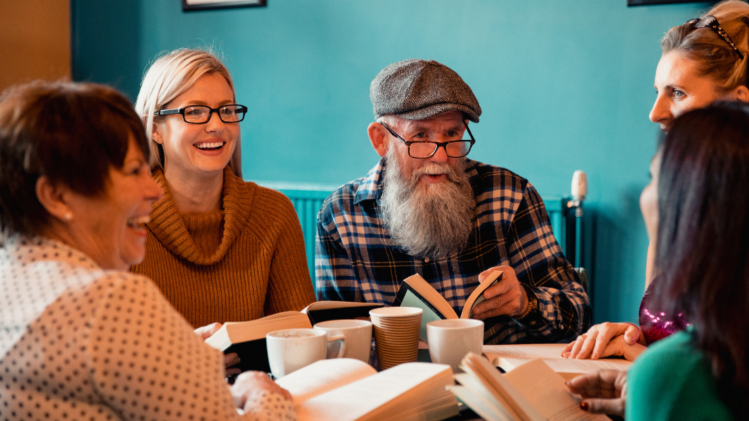 group of people discussing a book