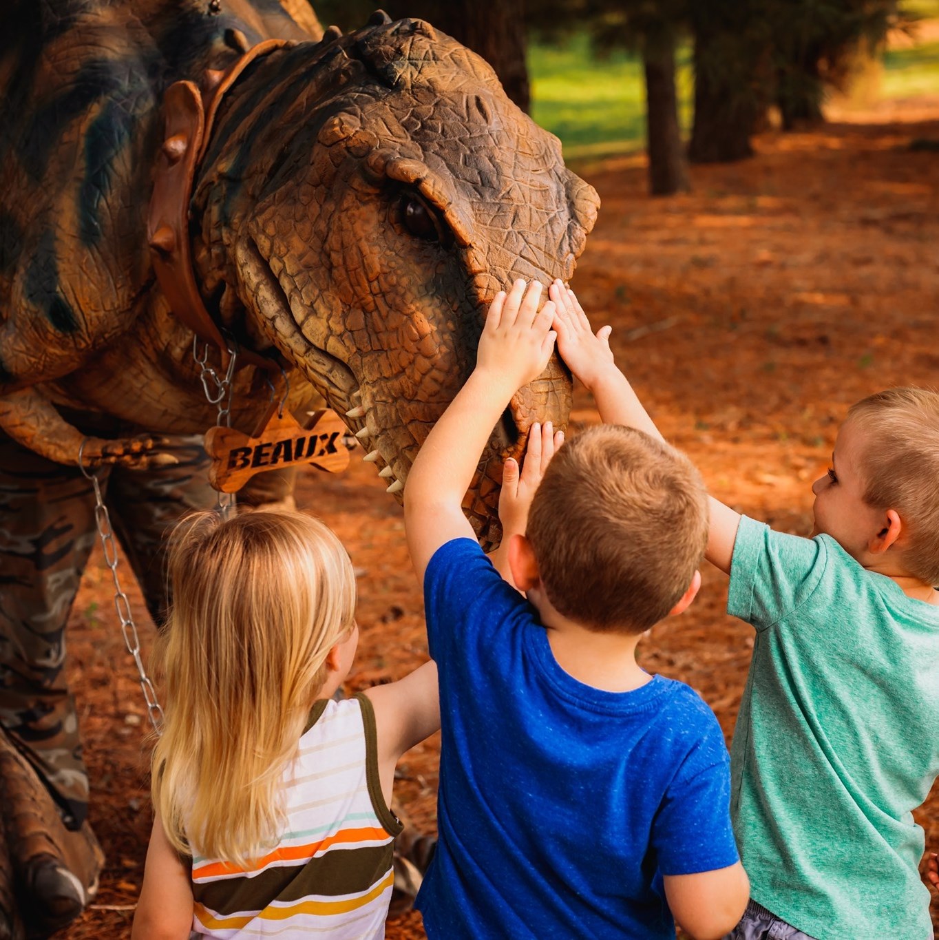 Kids petting dinosaur