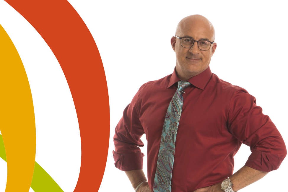 A photo of meteorologist Jim Cantore in a red shirt and tie