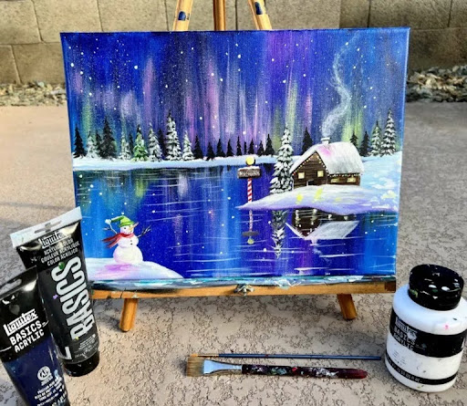 Painting of the northern lights over a lake with a cabin and snowman