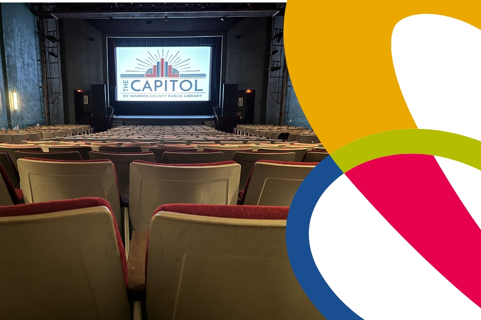 The interior of the Capitol's theater with the Capitol's logo on the screen
