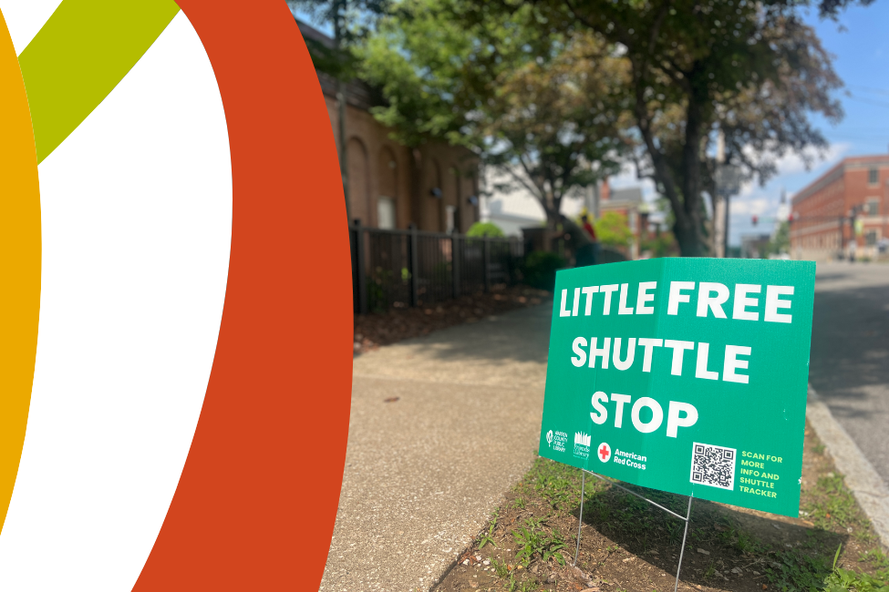 A Little Free Shuttle Stop sign in front of the Lisa Rice Library