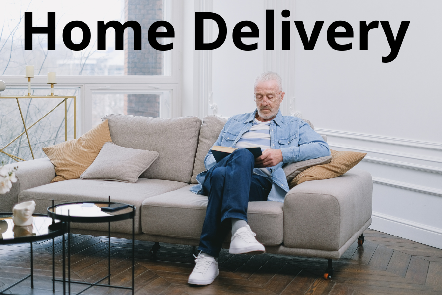 A man reading a book on a couch