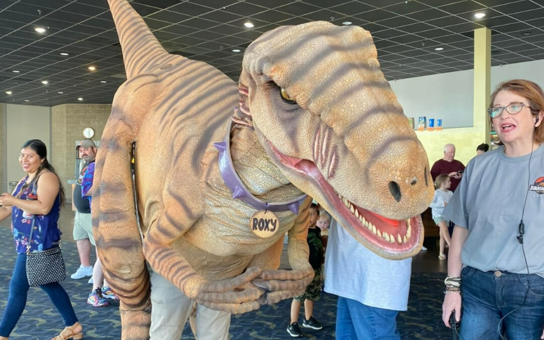 A person in a realistic raptor costume