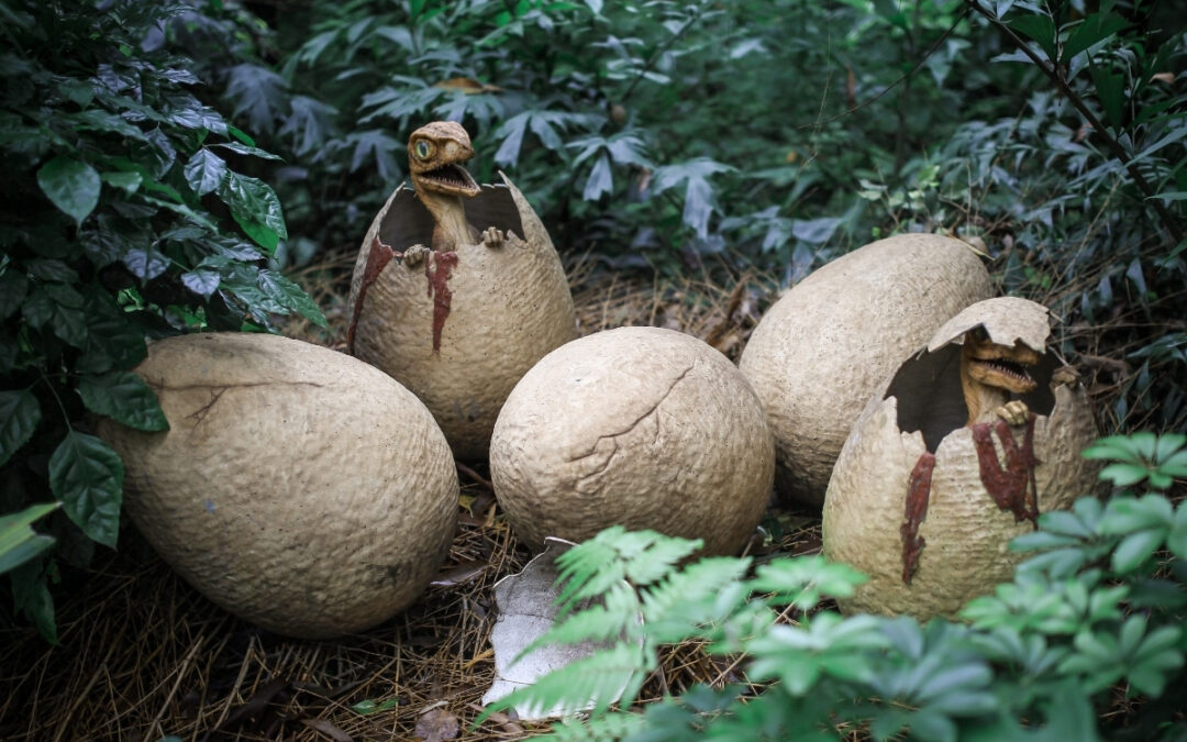 Baby dinosaurs hatch from eggs in a jungle