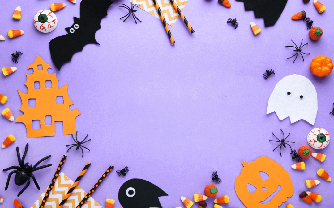 Halloween decorations scattered across a purple backdrop