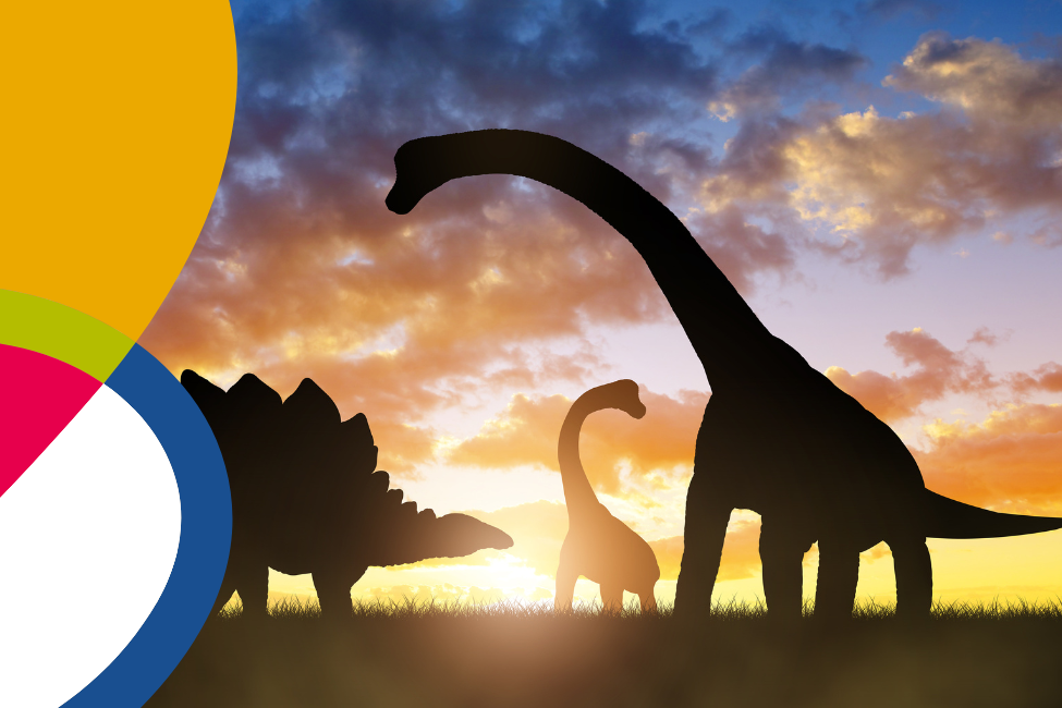 silhouette of three dinosaurs at sunset