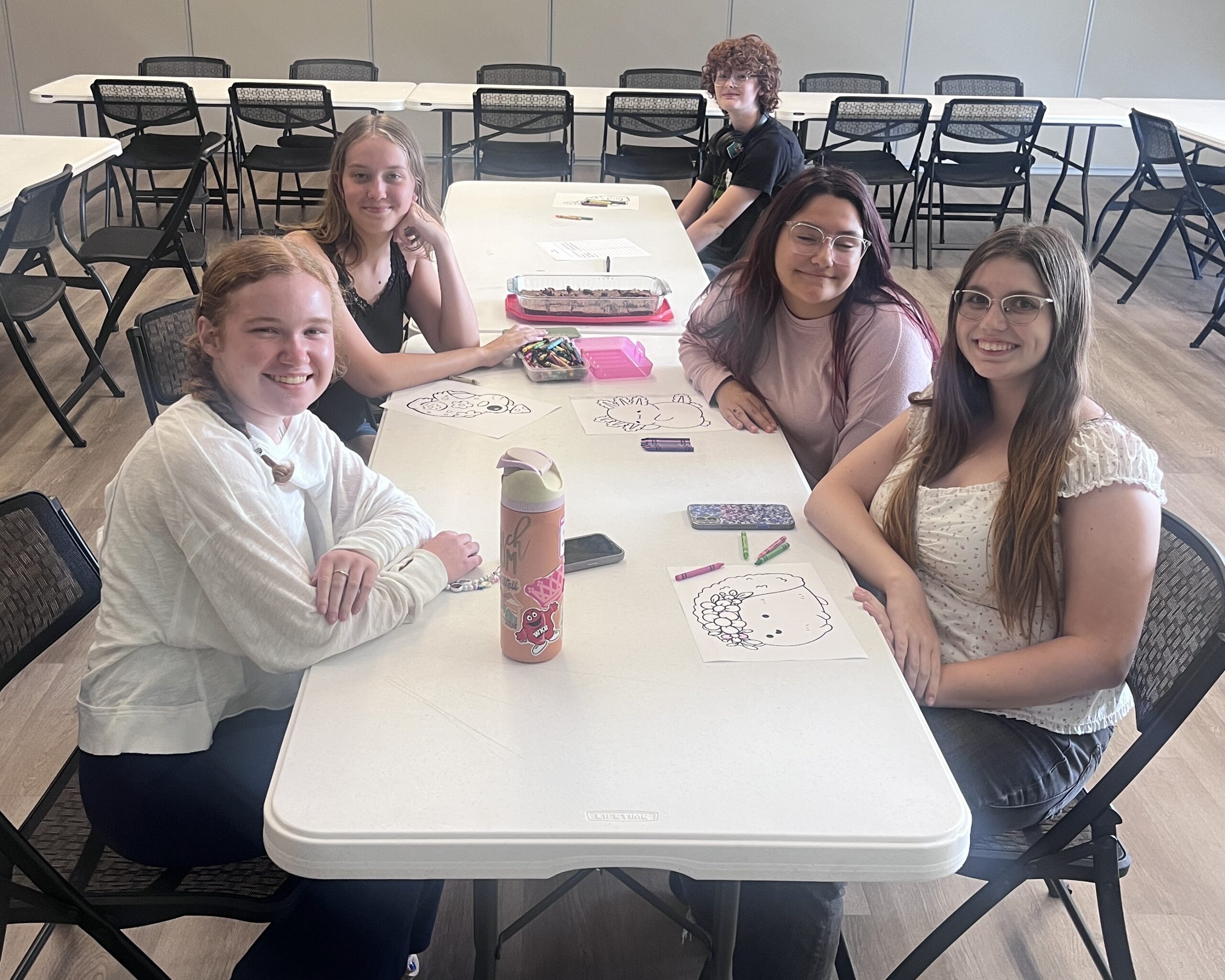 Teens at a table smiling