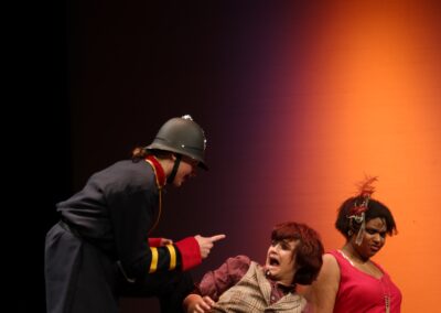 A police pointing to a person who looks afraid