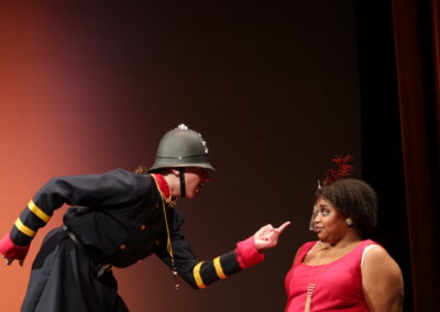 A police pointing to a woman in a red dress