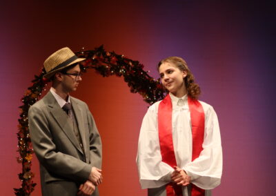 A wedding officiant with a man in a hat