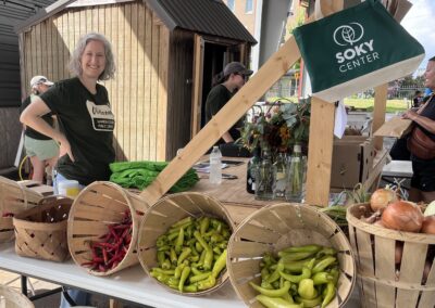 Library staff member standing at produce booth