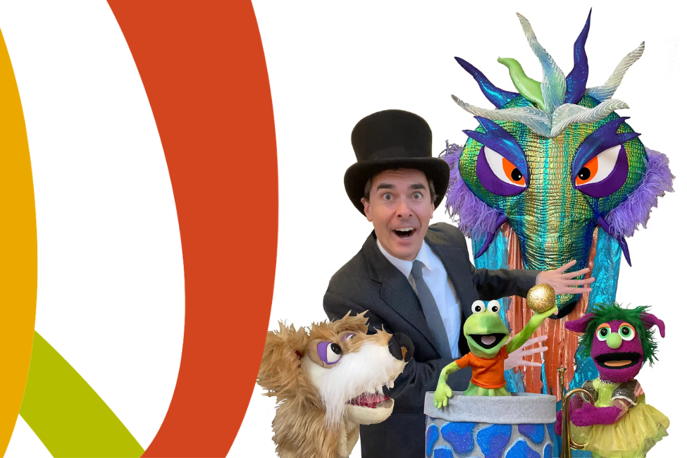 A picture of a man in a top hat and puppets - a dragon, a dog, a frog, and a girl.