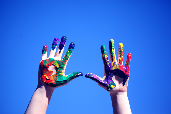 Hands covered in paint