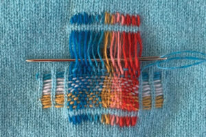 Mending needle in a knitted project
